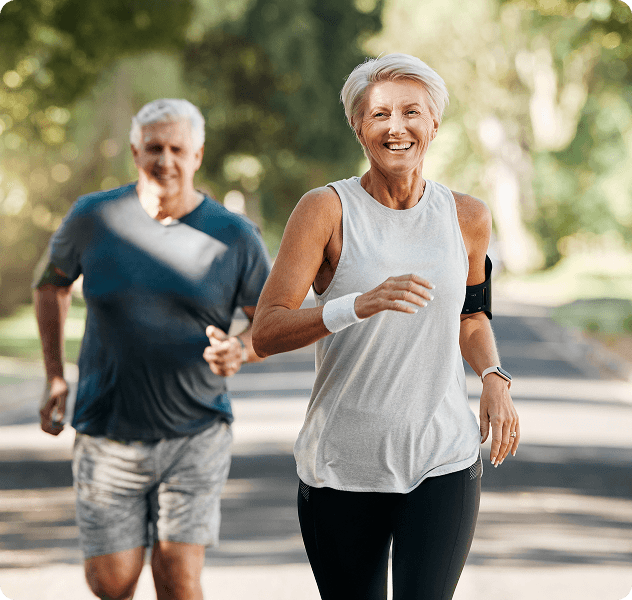 Two people jogging down park path